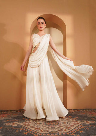 Ivory crepe blouse with pearl work & full-flair sharara with embroidered pallu.