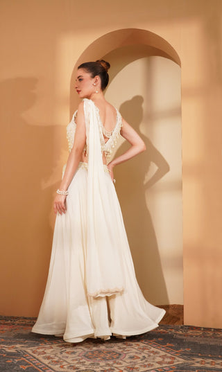Ivory blouse with hanging pearls, flair sharara & attached embroidered pallu.