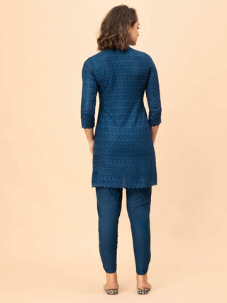 Collared v-neck Persian blue chikan top paired with border pants.
