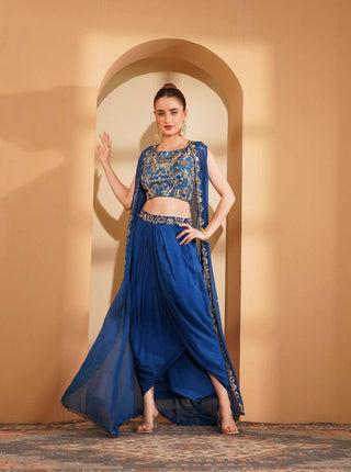 Deep blue embroidered boat neck blouse with scalloped organza cape & pleated skirt.