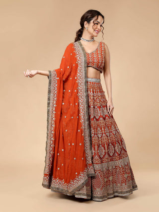 Embroidered rusty lehenga with zari work and cut dana blouse