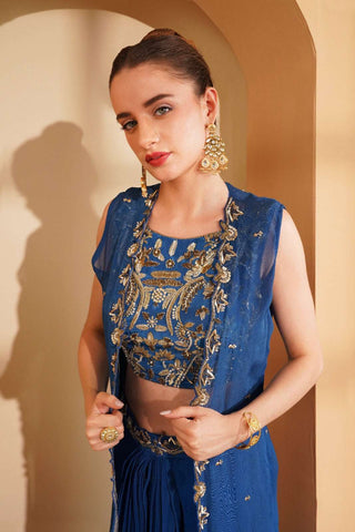 Heavy embroidered deep blue blouse with organza cape and draped pleated skirt.