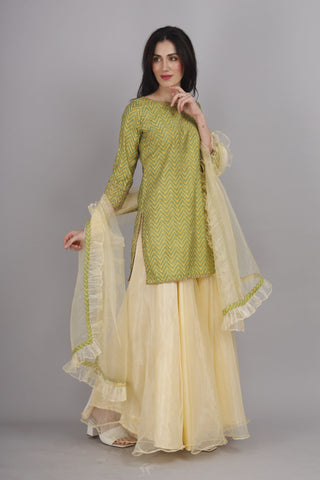 Lemon yellow sharara paired with zigzag print kurti and dupatta.