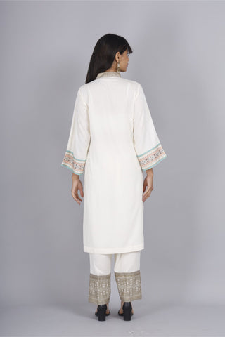 Off-white v-neck block print kurti and rayon hem pants set.