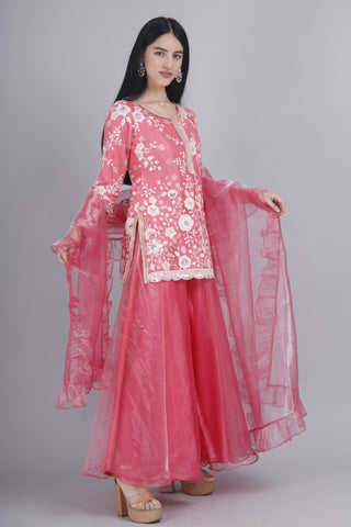 Pink sharara set with embroidered round neck kurti and dupatta.
