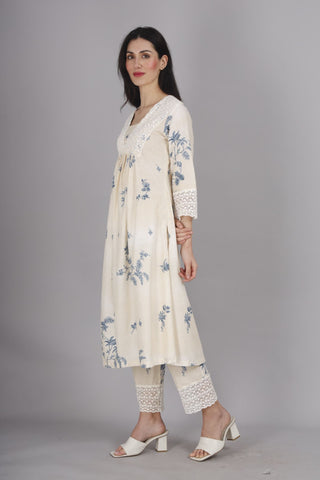 Printed off-white co-ord suit with lace details and straight pants.