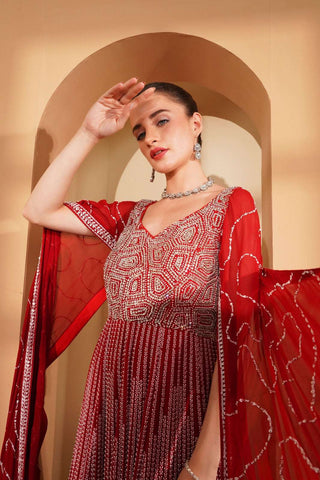 Red gown with silver & white embroidery, enhanced by long cape sleeves.