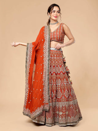 Rusty lehenga with multi-colored zari work, cut dana blouse, dupatta