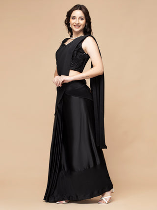 Black satin pre-draped saree paired with beaded embroidery blouse.
