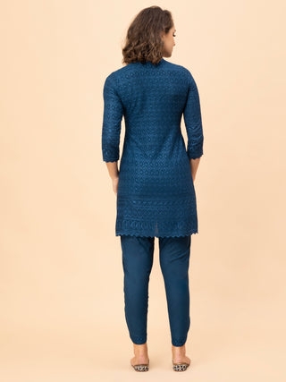 Collared v-neck Persian blue chikan top paired with border pants.
