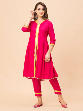 Cotton rayon hot pink kurti with gota detailing and pants.