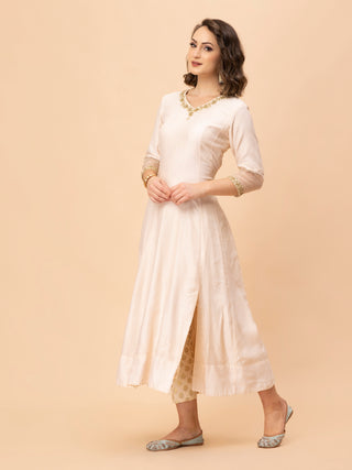Elegant ivory Anarkali with dabka and sequin embroidery, brocade pants.