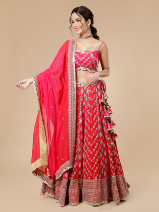 Elegant red and pink lehenga with zari work and noodle strap blouse