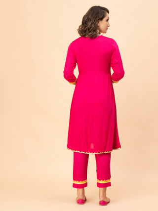 Hot pink suit with side gathered gota work and chinon dupatta.