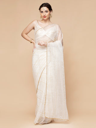 Ivory organza saree with bead embroidery, satin petticoat, and sequined blouse.
