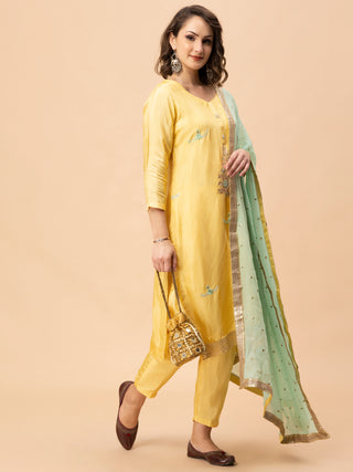 Lemon yellow silk suit with gota patti work and sea green dupatta.