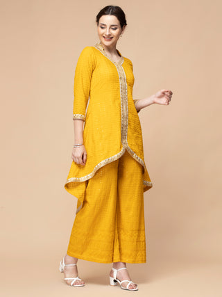 Mustard yellow chikan kurti with gota patti and flared plazzo.