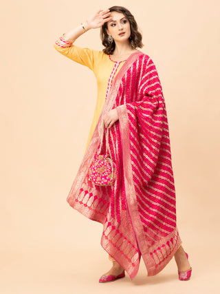 Peach Anarkali set with colorful borders, cotton pants, and dupatta.