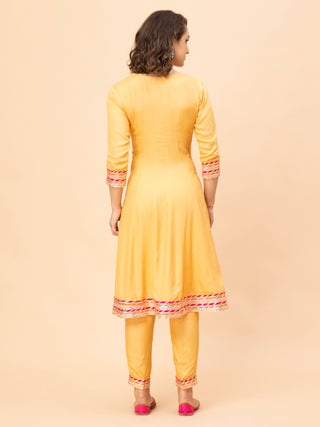 Peach front-open Anarkali suit with brocade dupatta and cotton pants.