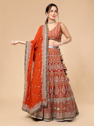Rusty lehenga with multi-colored zari work, cut dana blouse, dupatta