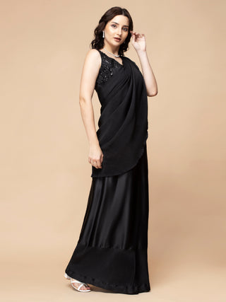 Stylish black pleated saree set with embroidered strappy blouse.